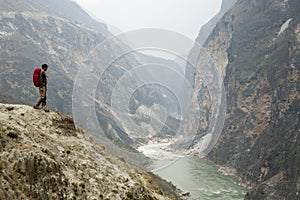 Hiker on Steep Mountain Path photo