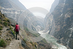 Hiker on Steep Mountain Path photo