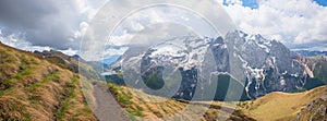 hiker at stunning hiking route from Pordoijoch to lake Fedaia, dolomites south tyrol