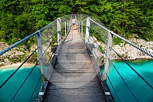 Hiker on the suspended bridge over the Isonzo river, Slovenia