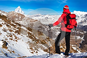 Hiker takes a rest admiring the Matterhorn peak.