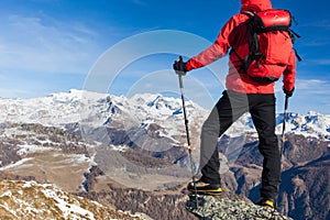 Hiker takes a rest admiring the mountain landscape. Sunny day, e
