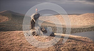 Hiker on top of a cliff admiring the landscape