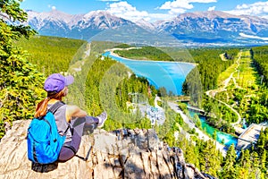 Staycation hiker on top of mountain overlooking local town of Canmore and Kananaskis photo