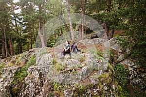 Hiker on top of mountain, woman sitting on the edge of the rock