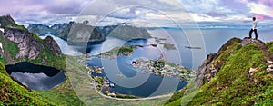 Hiker on top of Mt. Reinebringen, Lofoten islands, Norway photo