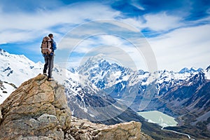 Hiker at the top of a rock with backpack