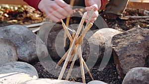 Hiker tourist striking ferrocerium rod to make bonfire on hiking adventure