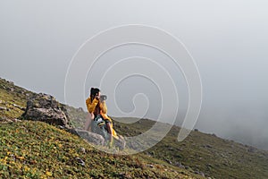 Hiker tourist woman photographer taking pictures with camera in the beautiful nature.