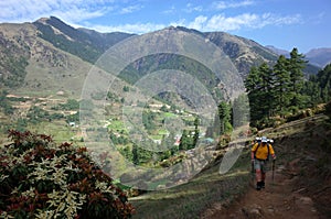 Hiker trekking in green mountains on trail between Jiri and Lukla, Lower part of Everest trek