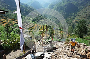 Hiker trekking in green mountains up on trail between Jiri and Lukla - lower part of Everest trek in Himalayas