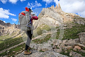 Hiker use smartphone in mountain top rock