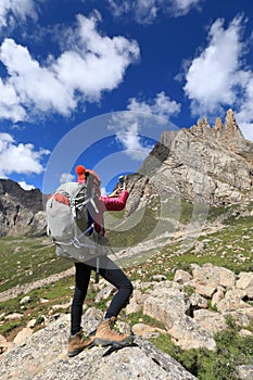 hiker use smartphone in mountain top rock