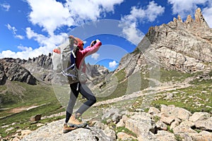 Hiker use smartphone in mountain top rock