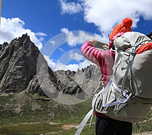 Hiker use smartphone in mountain top rock