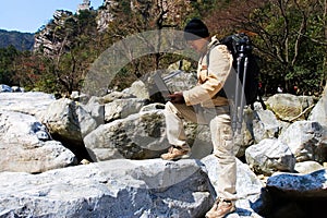 Hiker using a laptop outdoors