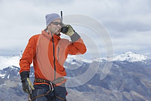 Hiker With Walkie Talkie Against Mountain Peak