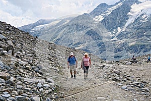 hiker walking along a path at Grossglockner Mountain and Pasterze in Austria. Summer.