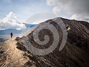 Hiker Walking Around Rim of Gunung Bromo Volcano, Java, Indonesia