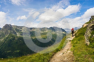 Hiker walking on a beautiful path in Aiguilles Rouges