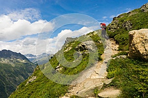 Hiker walking on a beautiful path in Aiguilles Rouges