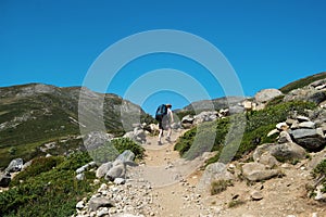hiker walking on Besseggen ridge in Jotunheimen National