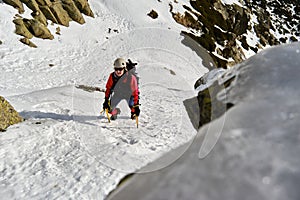 Hiker walking on snowy mountain slope