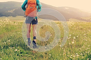 Hiker walking on trail in grassland
