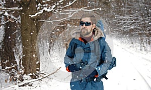 Hiker walking in winter forest