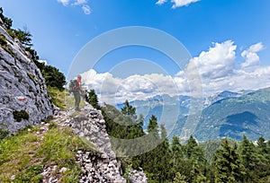 Hiker walks on a mountain trail with wonderful view to admire.