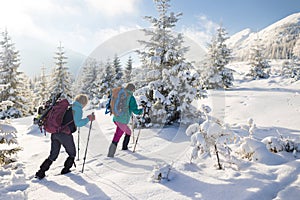 A hiker walks in snowshoes in the snow