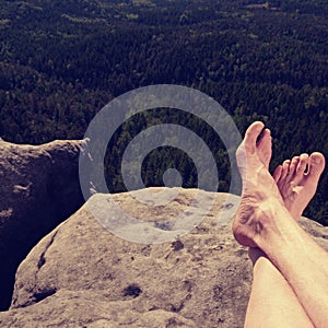 Hiker watching hilly landscape over own hairy legs photo