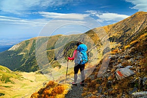 Hiker woman with backpack in Fagaras mountains, Transylvania, Romania, Europe