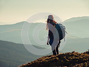 Hiker Woman with Backpack on Top of a Mountain