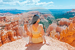 Hiker woman in Bryce Canyon resting enjoying view in beautiful nature landscape with hoodoos, pinnacles and spires rock