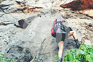 Hiker woman climb up the last section in mountains. Traveler walking in outdoor lifestyle adventure