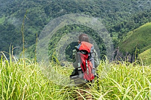 Hiker woman climb up the last section in mountains. Traveler walking in outdoor lifestyle adventure