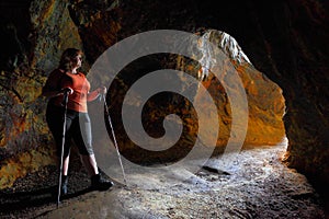 Hiker woman explore ancient underground mine.