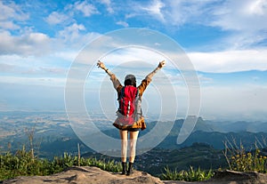 Hiker woman feeling victorious facing on the mountain