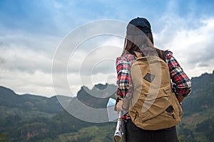 Hiker woman feeling victorious facing on the mountain,