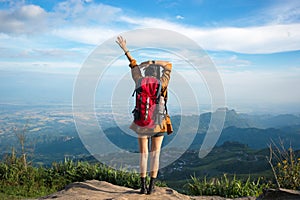 Hiker woman feeling victorious facing on the mountain,