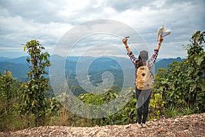 Hiker woman feeling victorious facing on the mountain,