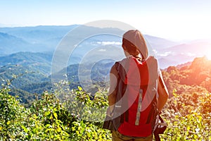 Hiker woman feeling victorious facing on the mountain