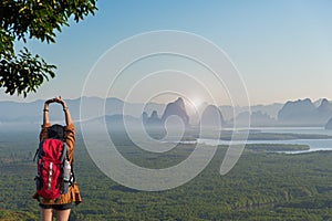 Hiker woman feeling victorious facing on the mountain