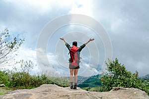 Hiker woman happy feeling freedom good and strong weight victorious facing on the natural mountain.