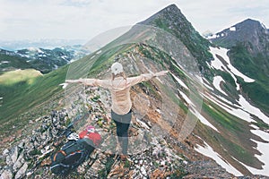 Hiker woman happy hands raised on mountain summit Travel Lifestyle adventure concept summer vacations outdoor exploring wild