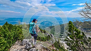 Petzen - Hiker woman looking at alpine valley on way to mountain peaks Feistritzer Spitze (Hochpetzen), Karawanks photo