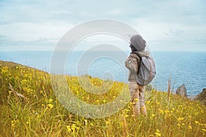 Hiker woman looks on the sea