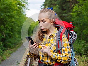 Hiker woman lost in forest. She using mobile GPS map.