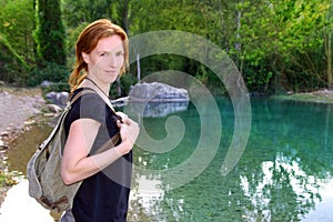 Hiker woman smiling backpack nature river lake